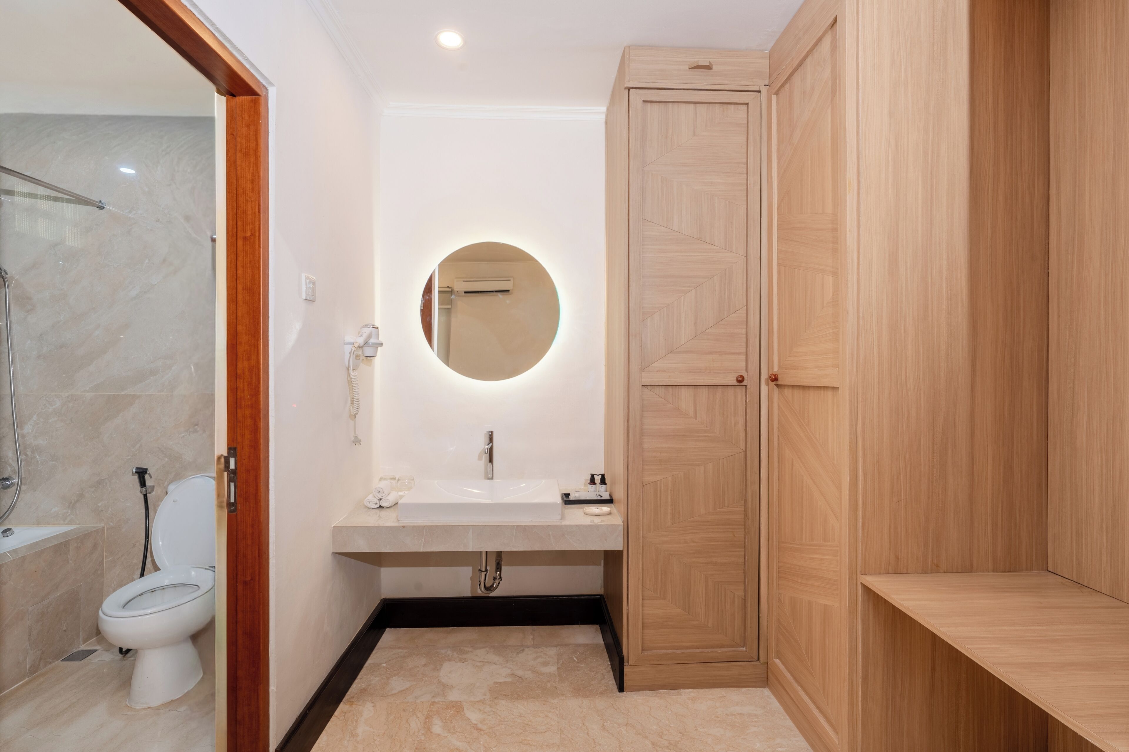 A modern bathroom with a toilet, sink, and shower.
