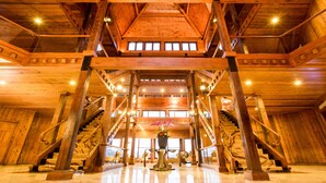 A spacious interior with wooden beams and a central staircase. - LEALEA GARDEN HOTEL SUN MOON LAKE (Yuchi)