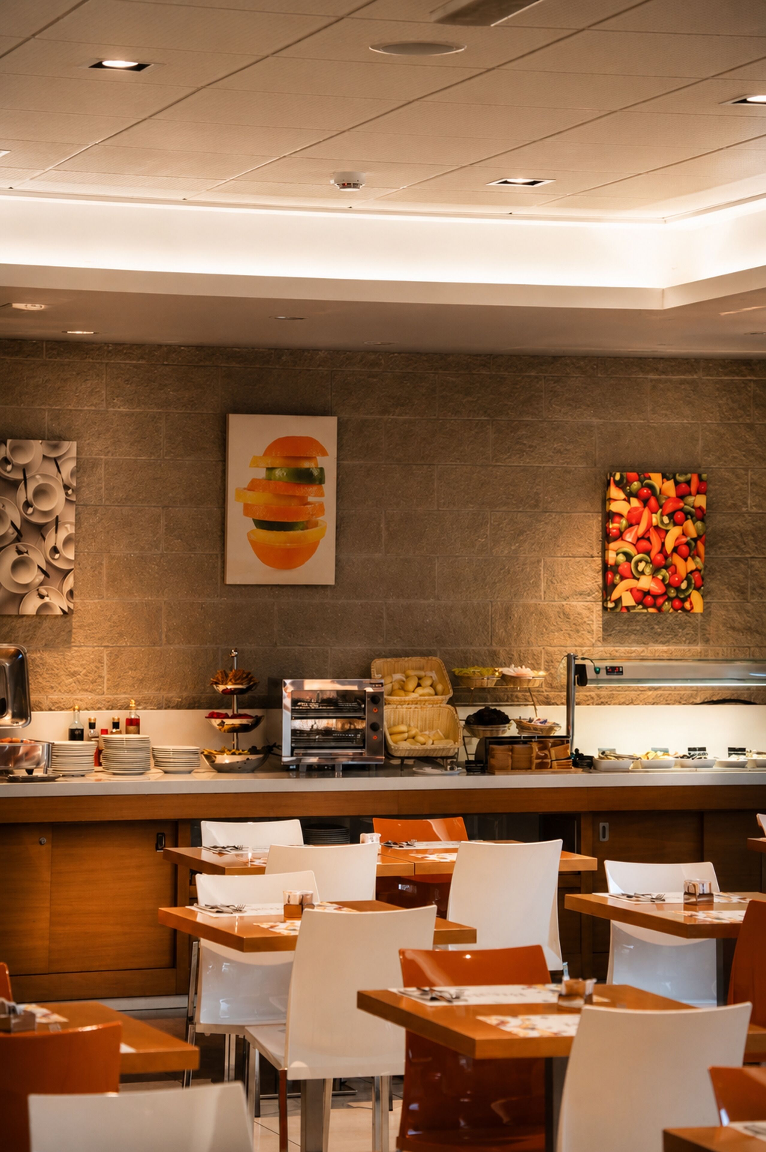 A restaurant with a buffet setup, including a food display and seating area.