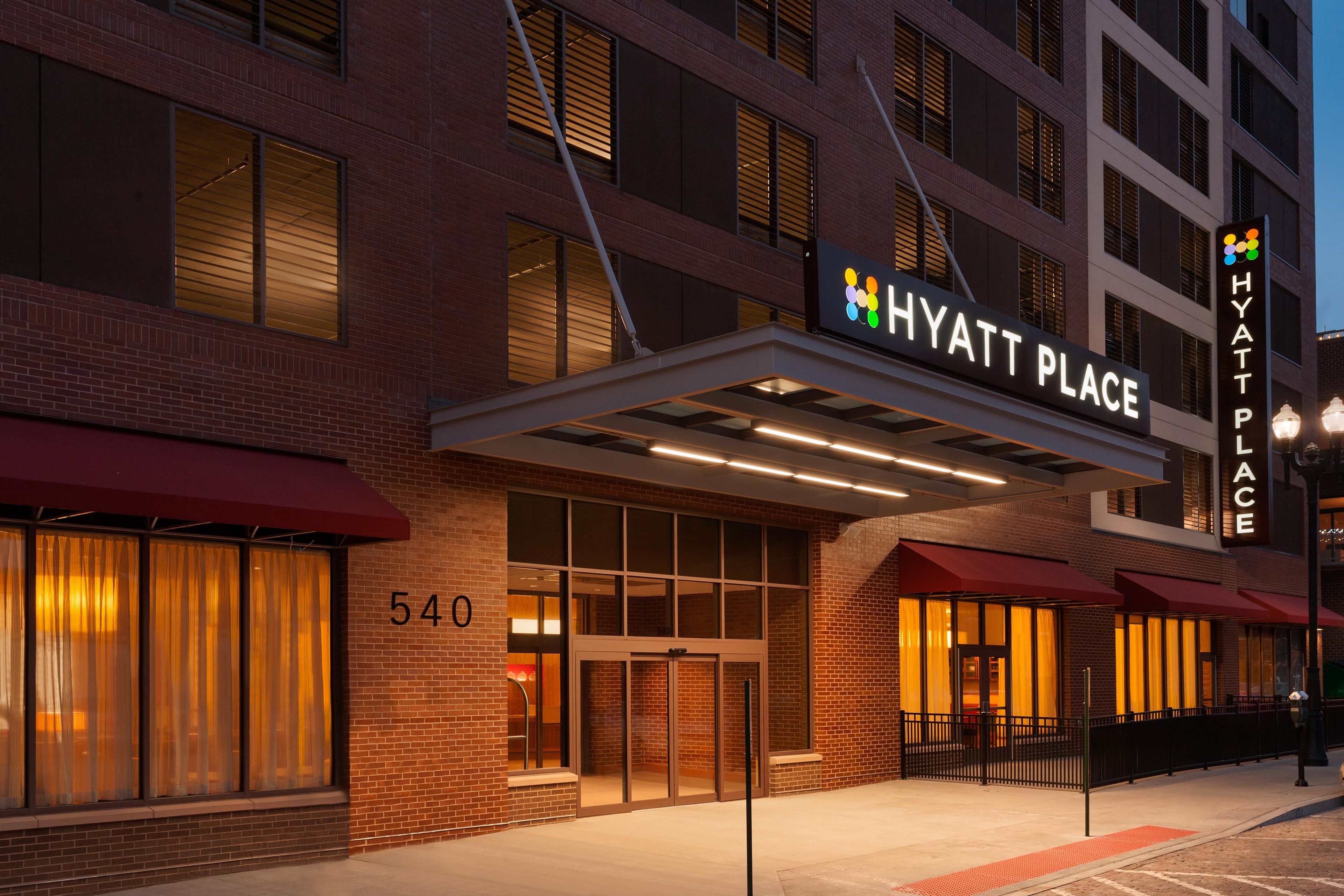 A brick building with a sign reading 'HYATT PLACE' and a number '540' on the facade.