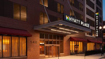 A brick building with a sign reading 'HYATT PLACE' and a number '540' on the facade.