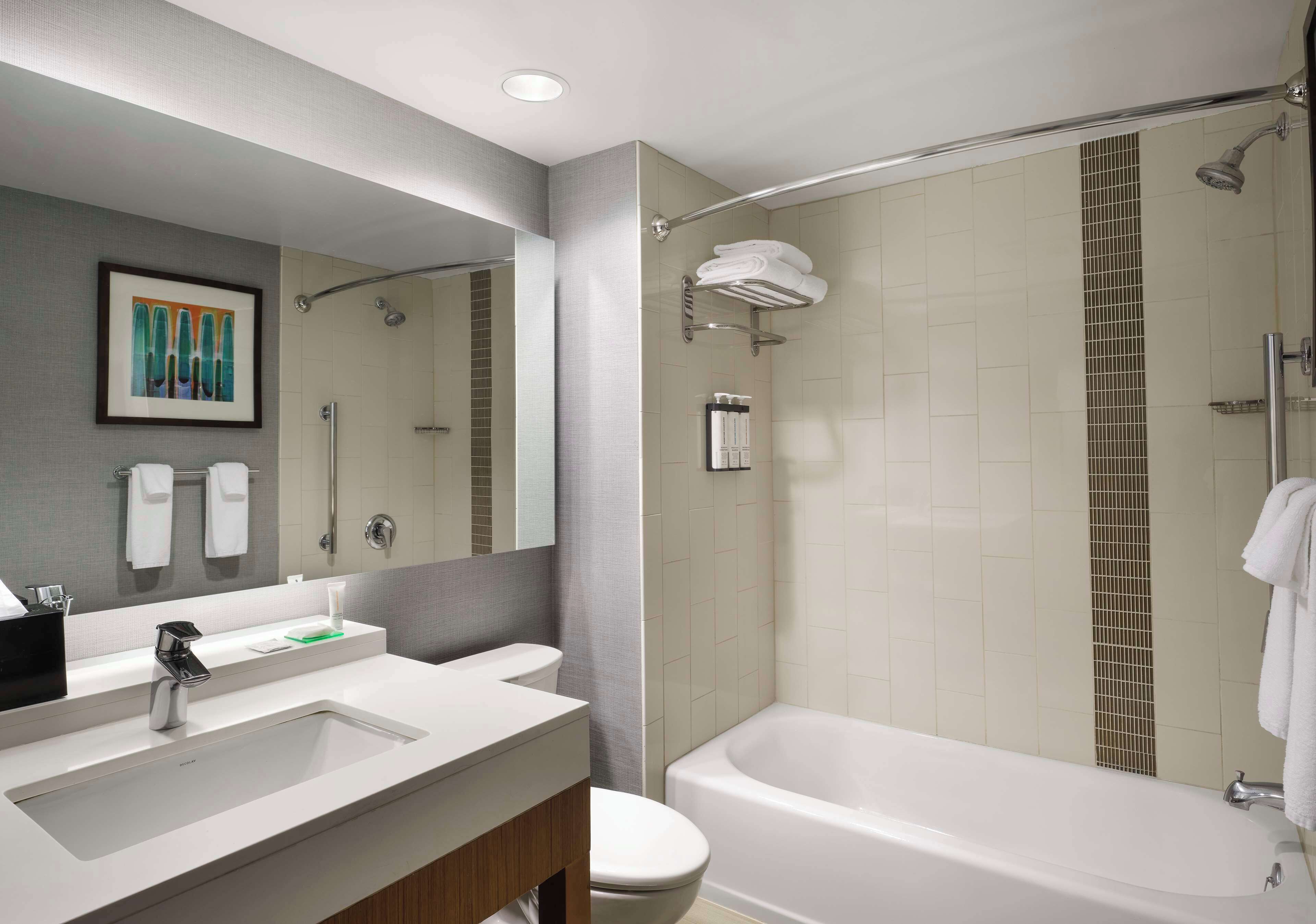 combined shower/bathtub, designer toiletries, hair dryer, towels