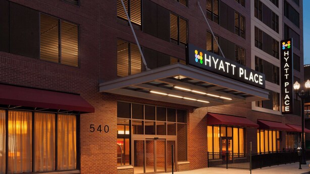 A brick building with a sign reading "Hyatt Place" and the number "540" on the facade.