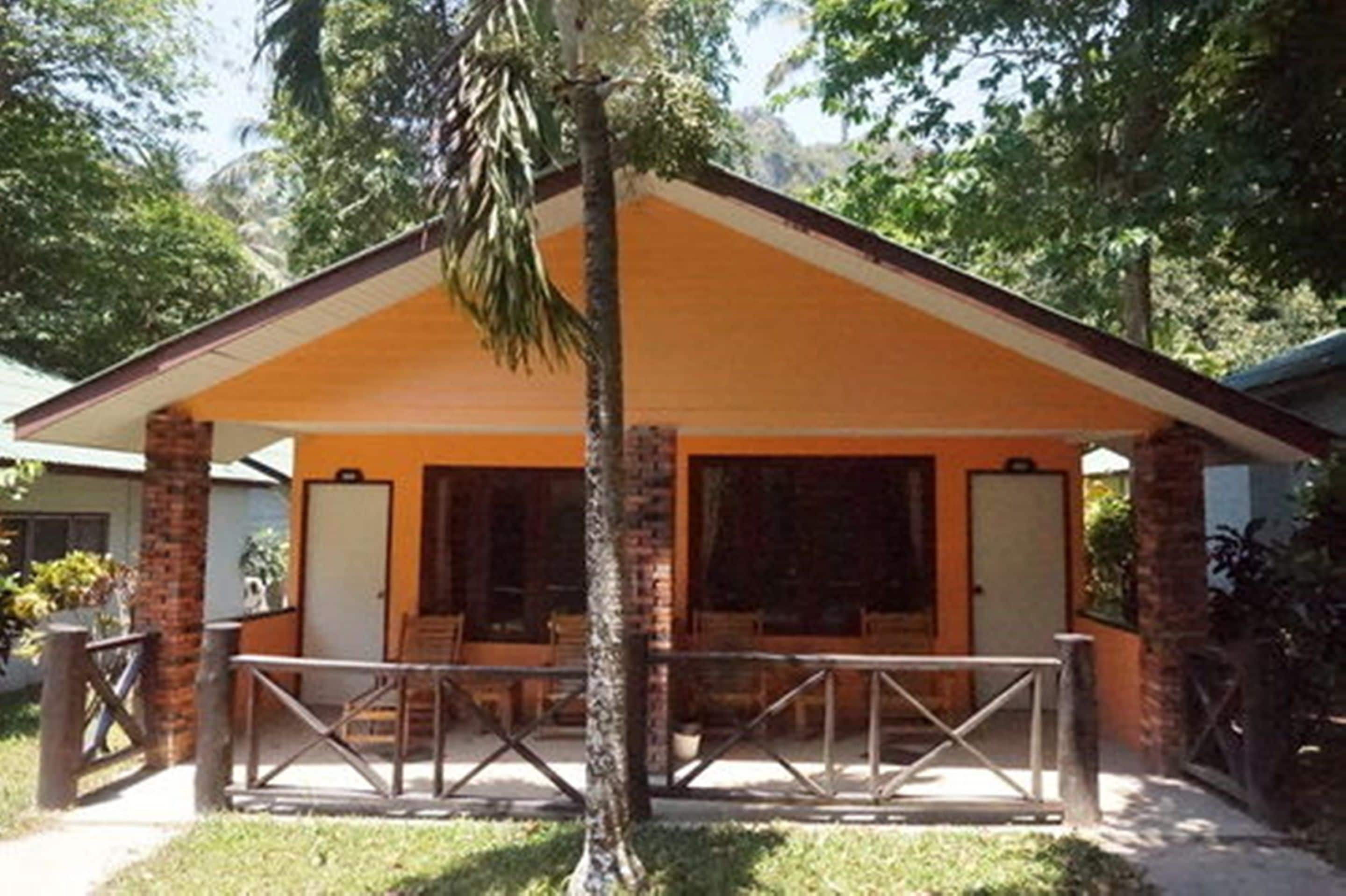 A single-story building with a covered patio area, a brick exterior, and a simple, functional design.