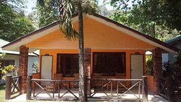 A single-story building with a covered patio area, a brick exterior, and a simple, functional design.