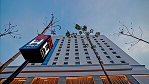 A tall building with a sign that reads "NOW OPEN" and "HABLS". - Hablis Hotel (Chennai)