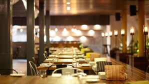A long dining table with chairs, candles, and a warm ambiance. - Hablis Hotel (Chennai)