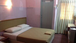 A hotel room with two beds, a desk with a computer, a wardrobe, and a curtain. - Hosaga Biz Hotel (KELANTAN)