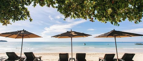 On the beach, white sand, beach towels, kayaking