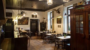A cozy restaurant interior with wooden tables and chairs, hanging lanterns, and a bar area. - Hotel zur Krone (Gescher)