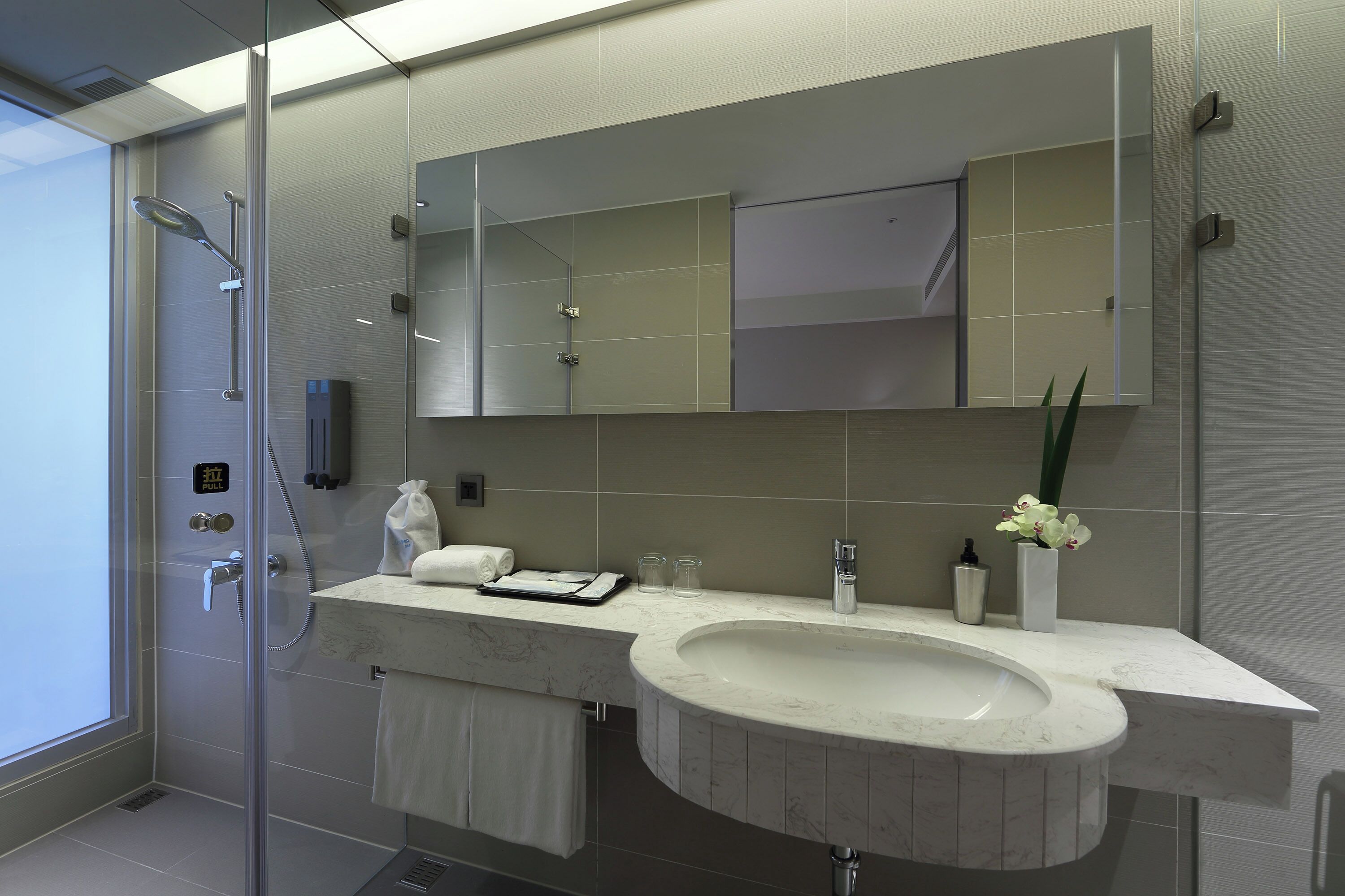 shower, hair dryer, slippers, towels