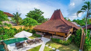 A villa with a swimming pool, outdoor seating, and lush greenery. - Dyana Villas (Seminyak)