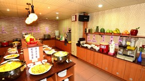 A buffet setup with various food items and condiments. - Li Qing Hotel (Kaohsiung)