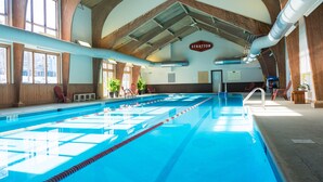 An indoor swimming pool with clear lanes, wooden beams, and a 'Stratton' sign. - Vantage Point Villas at Stratton Mountain Resort (Stratton)