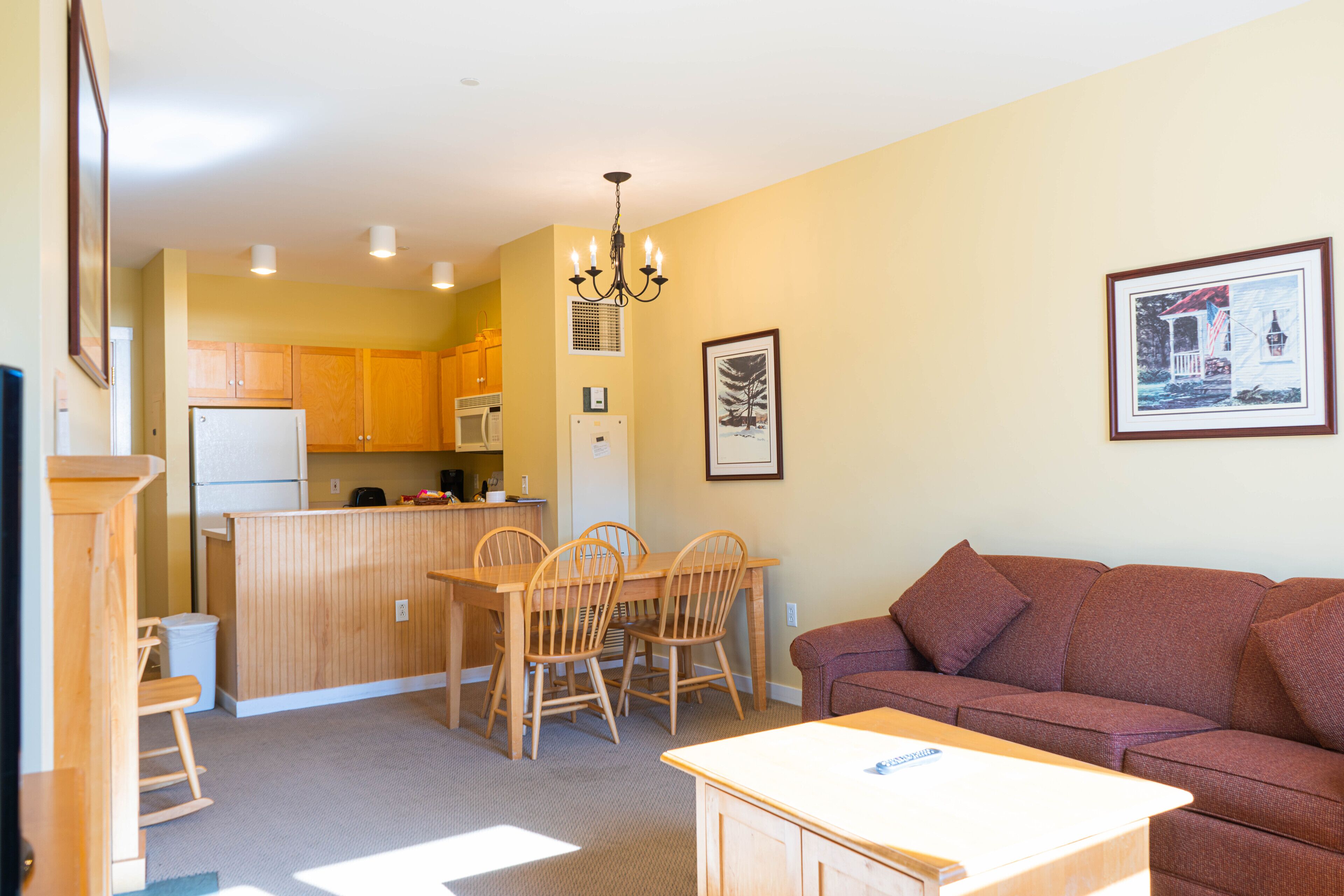 A compact living space with a kitchenette, dining area, and a seating area.