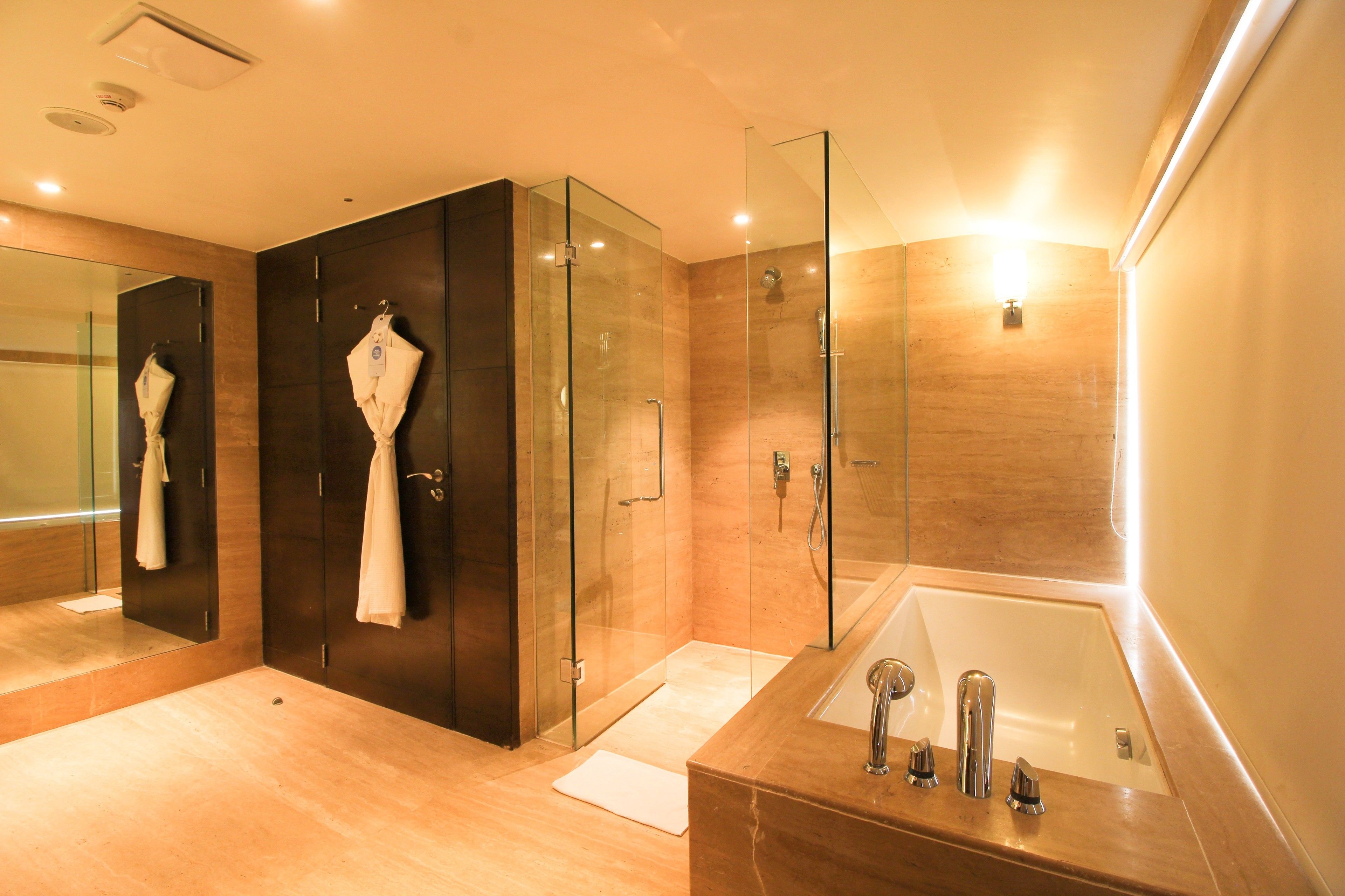 suite, 1 king bed, jetted tub (elegance) | bathroom | shower, rainfall showerhead, designer toiletries, hair dryer