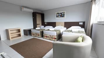 Deluxe Triple Room | Minibar, individually decorated, desk, blackout drapes