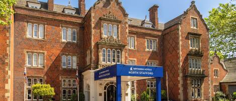 A historic brick building with a sign for Britannia Hotels North Stafford.