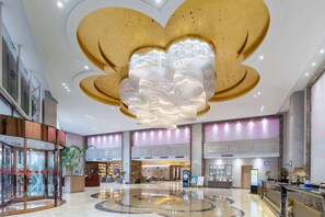 A spacious lobby with a large, circular marble floor, a prominent chandelier, and a reception desk. - Ramada Linyi North (Linyi)