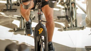 A gym with stationary bikes and a large window.