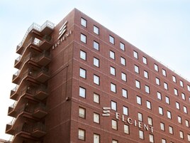 A multi-story building with a prominent 'ELCIENT' sign on the facade.