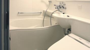 A modern bathroom with a bathtub, a sink, and a showerhead.