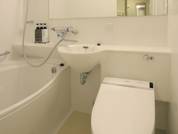 A modern bathroom with a bathtub, a sink, and a toilet.