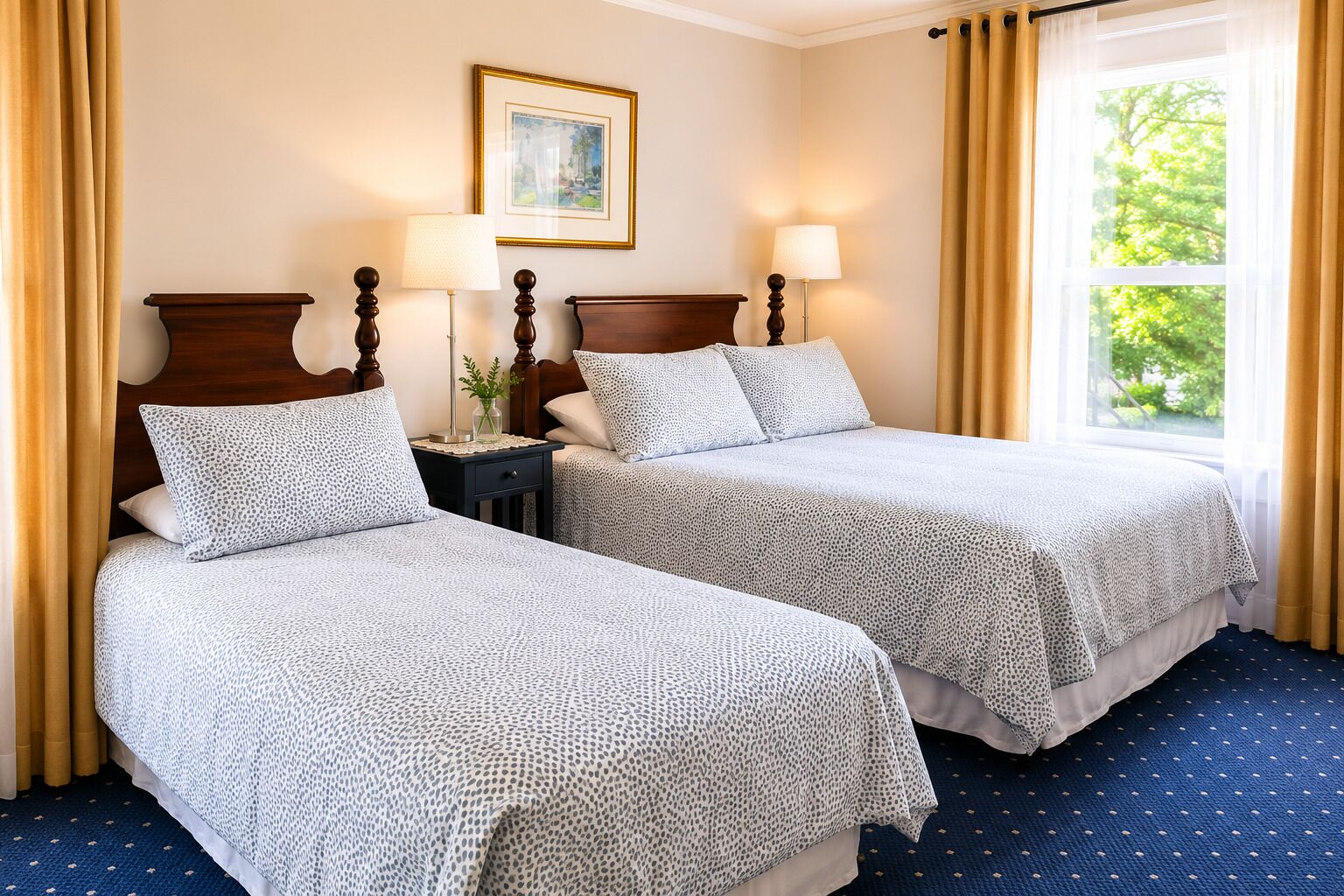 A hotel room with two beds, a nightstand, lamps, a framed picture on the wall, and a window with curtains.