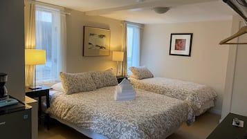 Comfort Room, 1 Bedroom, Private Bathroom (Lower Level) | Iron/ironing board, free WiFi, bed sheets