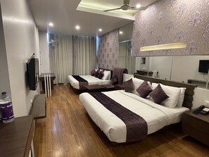 A hotel room with two beds, a mirror, a TV, and a water bottle. - Hotel Narula's Aurrum (Amritsar)