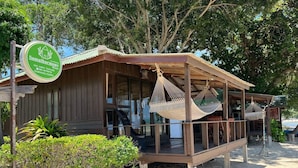 A wooden structure with a covered porch and a hammock. - Samui Harmony Resort (Koh Samui)