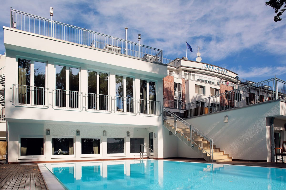 indoor pool, outdoor pool, open 7:00 am to 8:00 pm, pool umbrellas