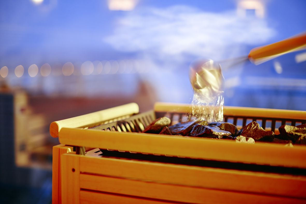 A wooden rack with dried fruits and a glass container.