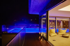 Una piscina al aire libre, sillones reclinables de piscina