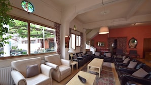 A spacious living room with a large window, a fireplace, and a view of the outside.