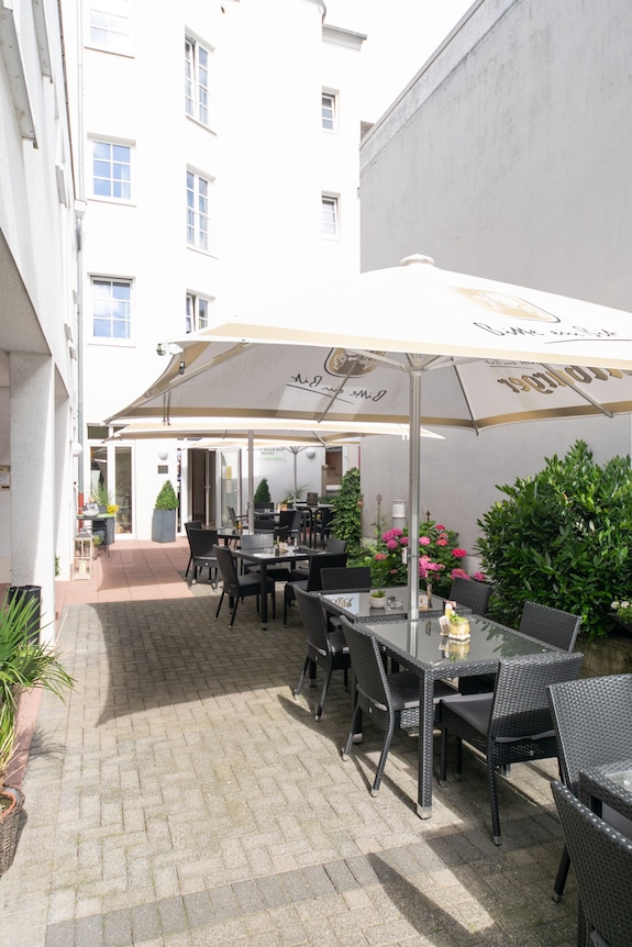 bitburger patio umbrella Business & Pleasure Co. The Three wind vents on top allow for air to flow and maintain stability Barbara King 360 Degree Offset