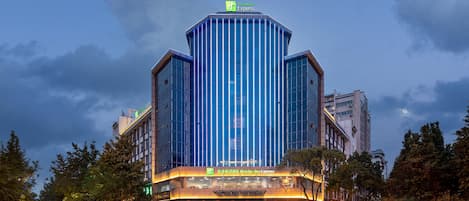 A hotel with a modern design, featuring a prominent 'Holiday Inn Express' sign.