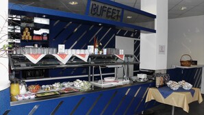 A buffet area with a blue and white color scheme, featuring a variety of food items and beverages. - Central Hotel Eberswalde (Eberswalde)