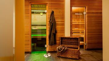 A wooden sauna room with a bench and a wicker basket.