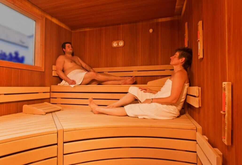 A sauna with wooden benches and a window.