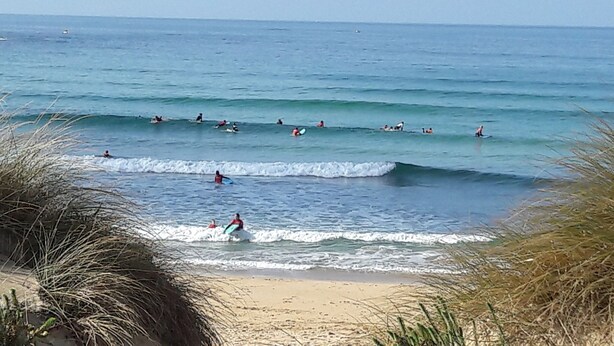 A beach with people surfing and swimming. - Hotel Torres Touriño (Sanxenxo)