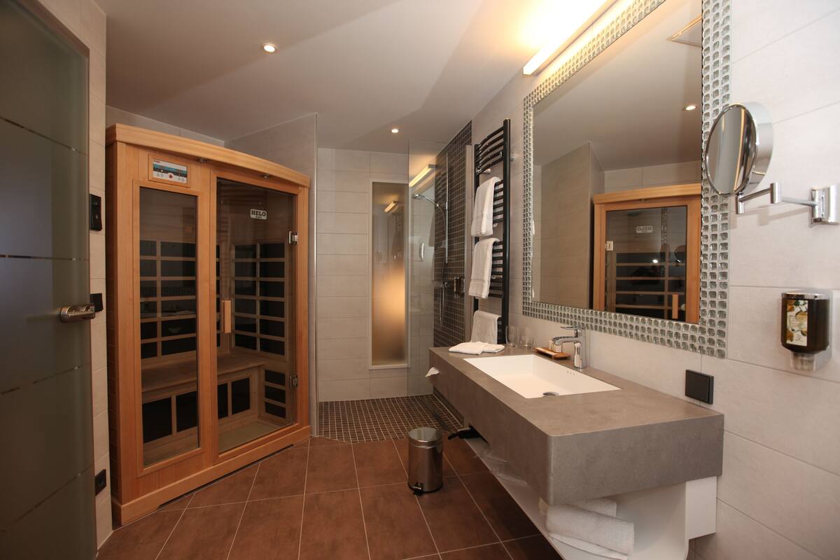 junior suite | bathroom | shower, slippers, towels