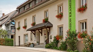 A building with a green vertical sign reading "Pension Kramer." - Pension Kramer (Grafenhausen)