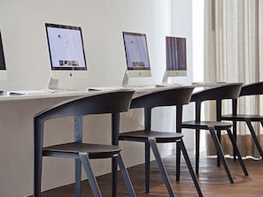 Work in comfort with a dedicated desk and three flat-screen monitors.