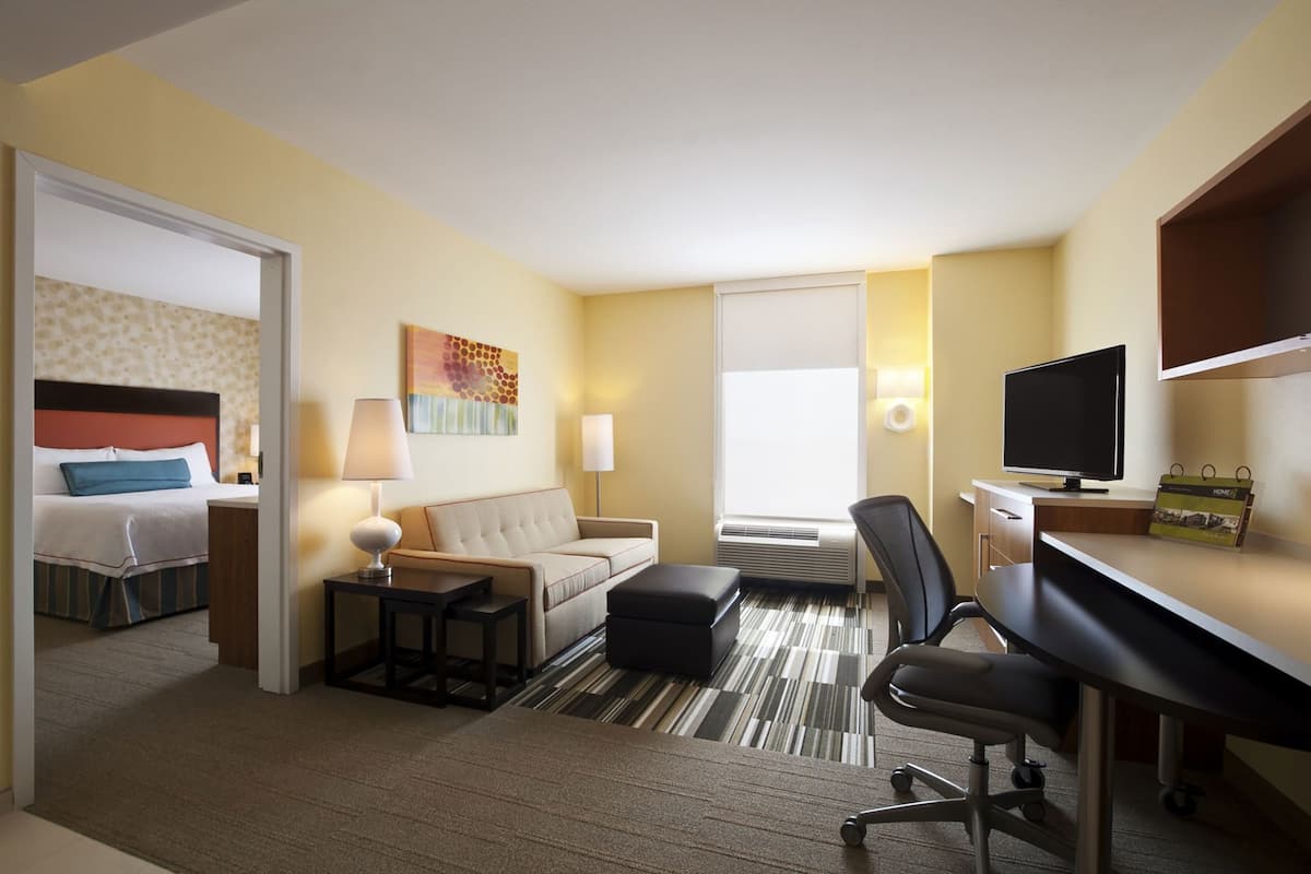 Hypo-allergenic bedding, desk, laptop workspace, blackout drapes
