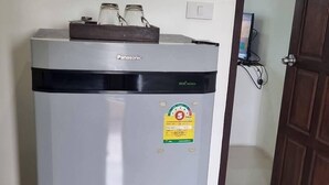 A compact, modern refrigerator with a sticker indicating energy efficiency. - Kanlaya Park Apartment Hotel (Koh Samui)