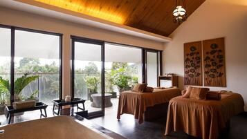 Enjoy a serene escape with a balcony view of lush greenery and a clear sky from this stylish room featuring two single beds and a cozy seating area.