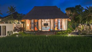 A thatched-roof building with a visible sign reading "aran junior". - Plataran Ubud Hotel & Spa (Ubud)