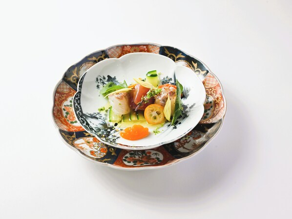 A bowl of food with a decorative pattern on the rim.