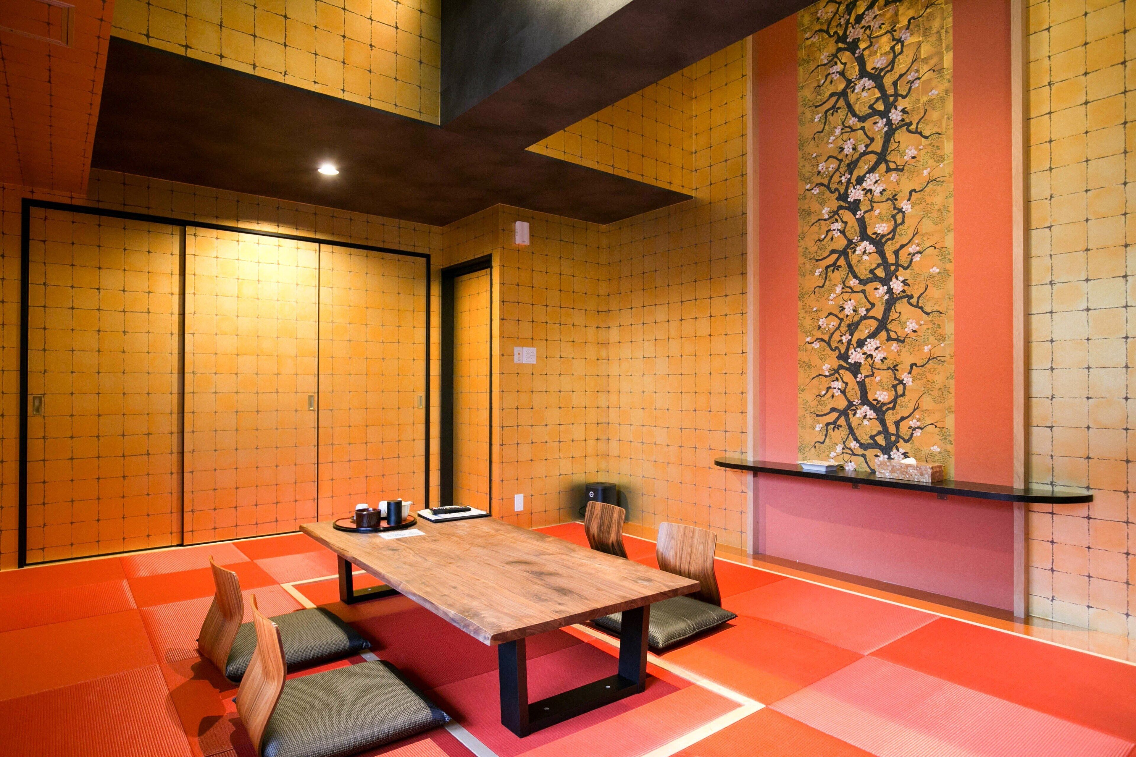 A traditional Japanese-style room with tatami flooring, a low wooden table, and shoji screens.
